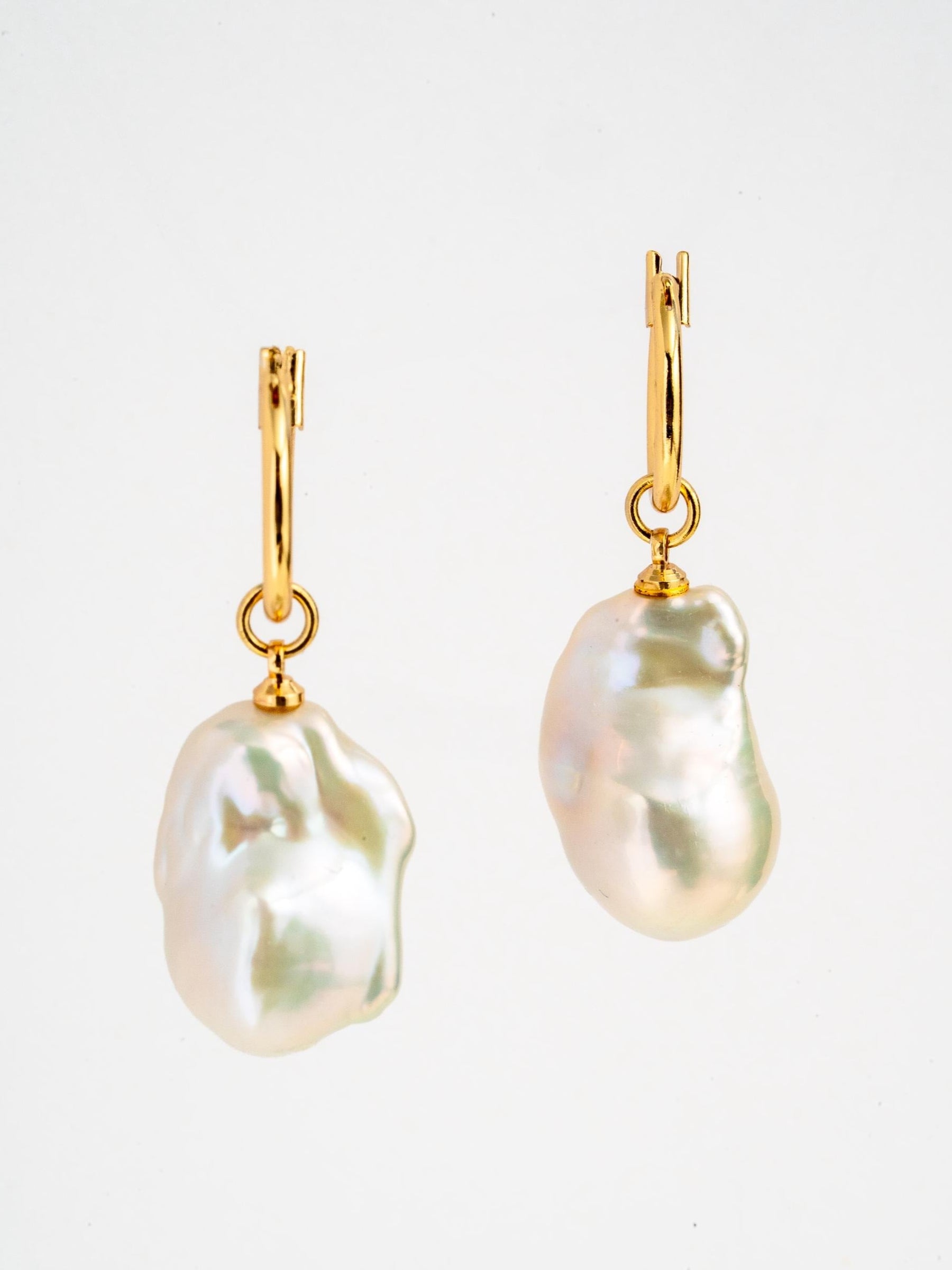 Gold hoop earrings with large baroque pearl charms